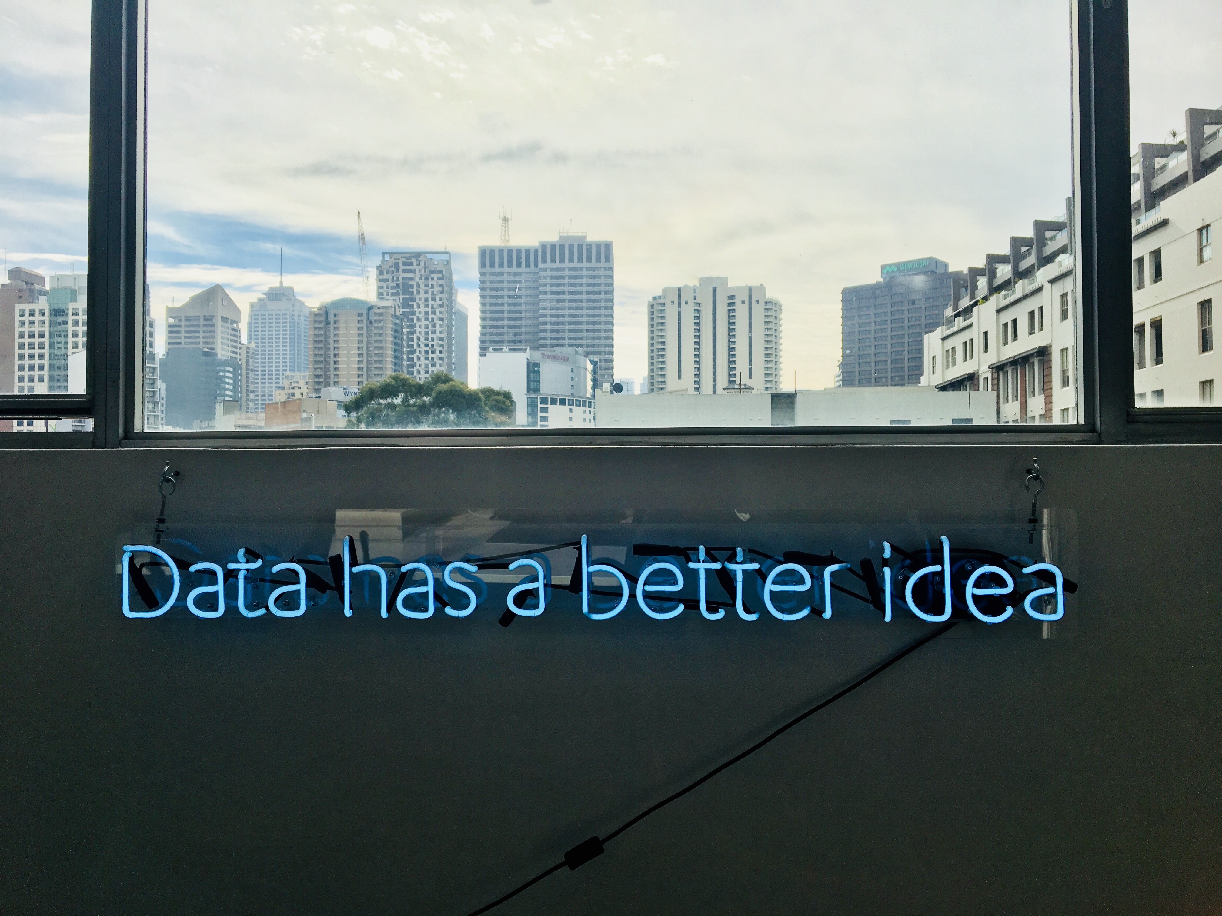City skyline out of window with 'Data has a better idea' written in lights