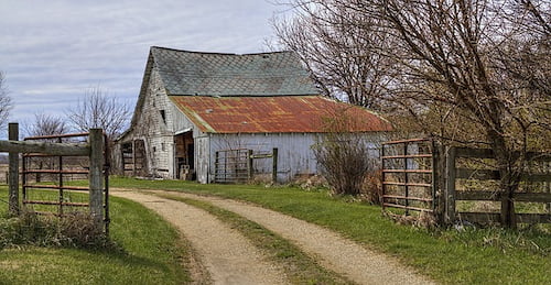 Old barn behind farm gate