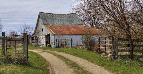 Old barn behind farm gate