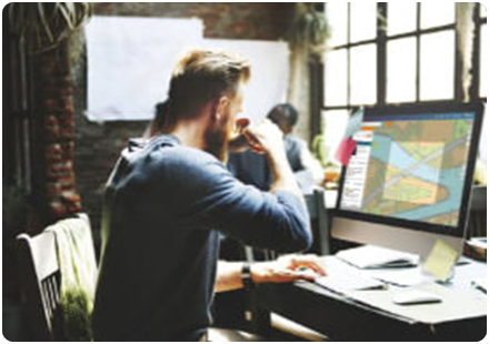 Man at desk using emapsite Mapshop on a computer